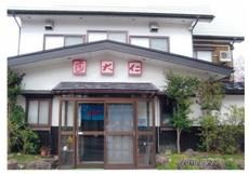 入り口に木々が生い茂る寿司処大仁の外観の写真