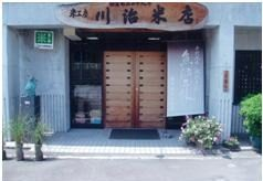 木の扉が特徴的な川治食品販売の外観の写真