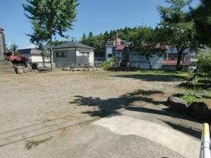 端に木が立っている宮本公園の広場の写真