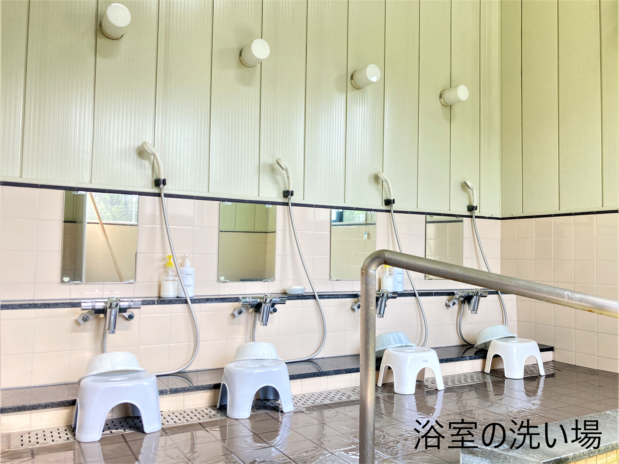 風呂の洗い場には鏡、シャワー、椅子、桶が四つずつ並んでいる