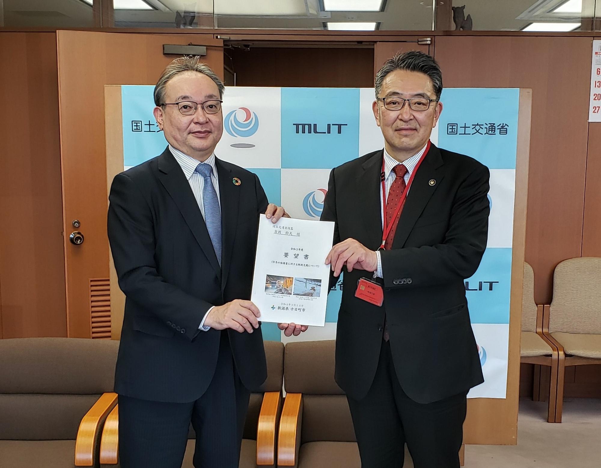 国土交通省の吉岡技監に要望書を渡す関口市長の写真