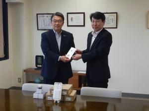 LED防犯灯贈呈式にて玉木所長より防犯灯を受領する市長の写真