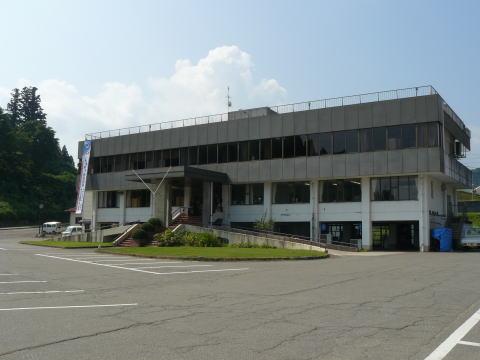 青空とスロープの入口がある松之山公民館の外観写真