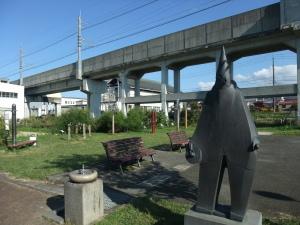 公園北側の景観の写真。写真手前に水飲み場や造形作品、奥にストレッチ器具類が設置されているのが確認できる