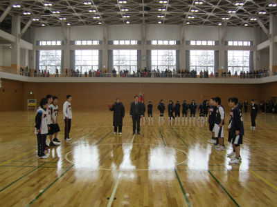 体育館でバスケットボール選手が整列している。