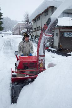 小型の除雪車で除雪している様子の写真