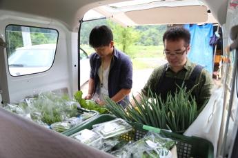 地域おこし協力隊員が野菜の集荷に取り組んでいる写真